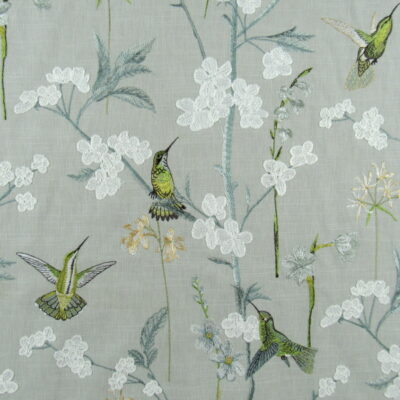 Hummingbird Garden Jade embroidery fabric is a stunning choice for upholstery and drapery, infusing elegance and a touch of nature into interior spaces.