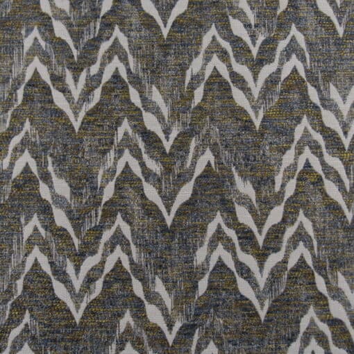 Trevi Fabrics Baliwick Bold features a navy, gold, brown chevron design, crafted as a durable jacquard weave fabric for upholstery, cushions, and pillows.