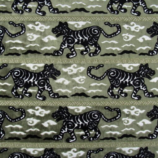Regal Fabrics Tigress Laurel showcases a bold tiger stripe pattern in green and black. This high-quality velvet is perfect for furniture upholstery, pillows, and cushions.