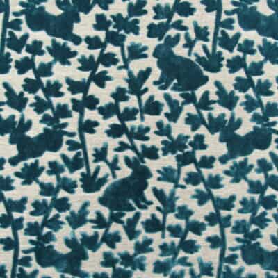 Covington Fabrics Luv Bunny 504 Azure is a high-quality cut velvet showcasing teal bunnies. This sturdy, abrasion-resistant fabric from Covington Fabric and Design is perfect for upholstery, cushions, and pillows.