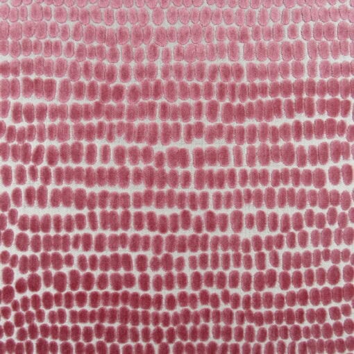 Trevi Fabrics River Stones Peony Velvet features a contemporary dot design in pink. This high-end cut velvet is perfect for furniture upholstery, cushions, and pillows.