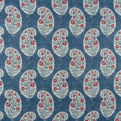 Covington Fabrics Kurta 593 Indigo showcases a small-scale paisley pattern with red and teal accents on a blue background, printed on a versatile linen-rayon blend. This fabric works perfectly for furniture upholstery, draperies, pillows, bedding, and cushions.