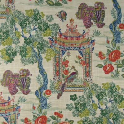 Utopian Garden Bloom showcases a pagoda-inspired design with Asian influences in vibrant greens, blues, reds, and oranges, set against a warm beige background. Printed on cotton-linen fabric, it’s perfect for drapery, bedding, upholstery, pillows, or cushions.